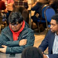 International Anchor Allies Winter 2026 First Mixer - crew members listening as another member makes a point